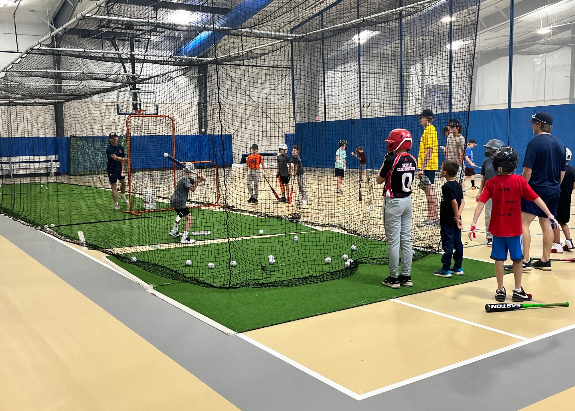 Youth athletes practicing batting skills in camp with the Culpeper Cavaliers 